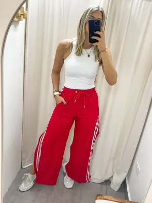 RED SIDE SLITS TRACK PANTS